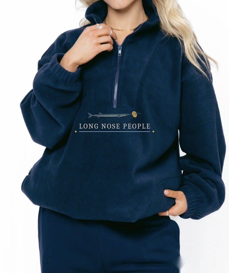 Mustique navy fleece quarter zip with an embroidered needlefish and Long Nose People lettering under the zip
