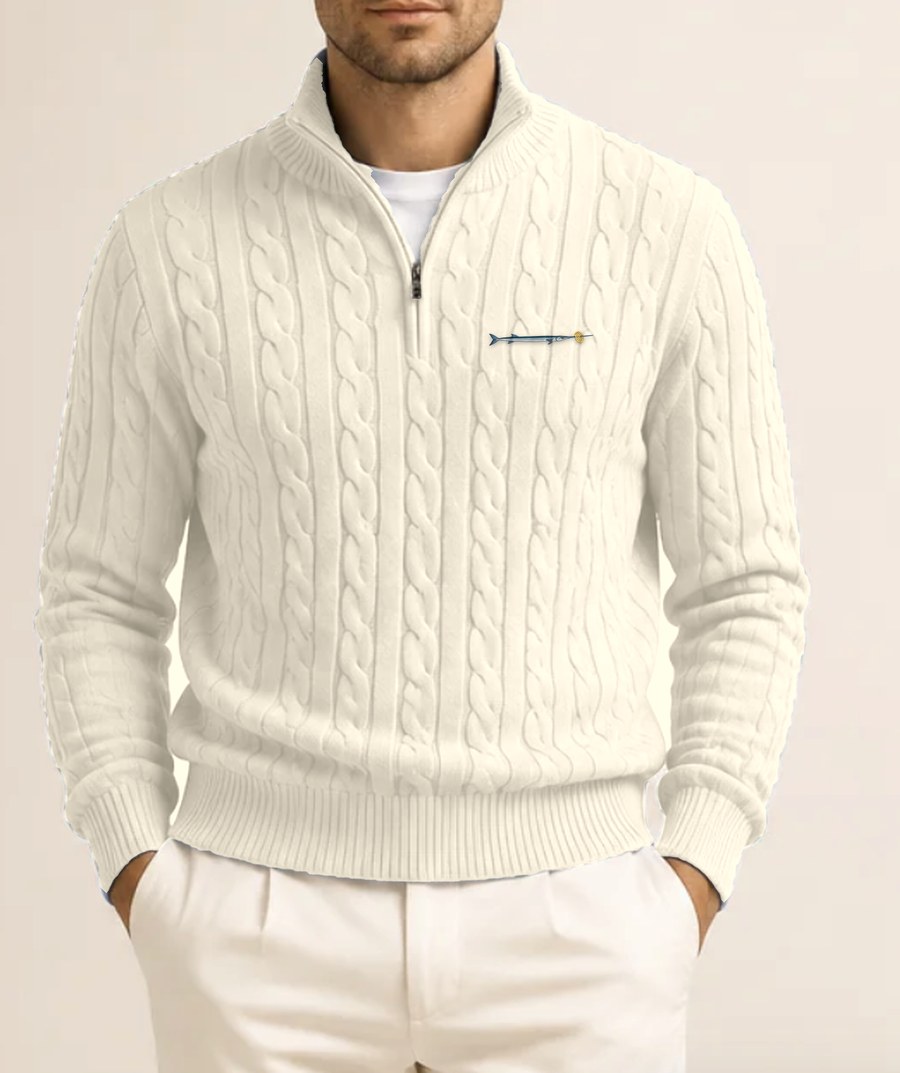 Ecru cable-knit quarter zip jumper with a small embroidered needlefish and lattice crisp on the chest